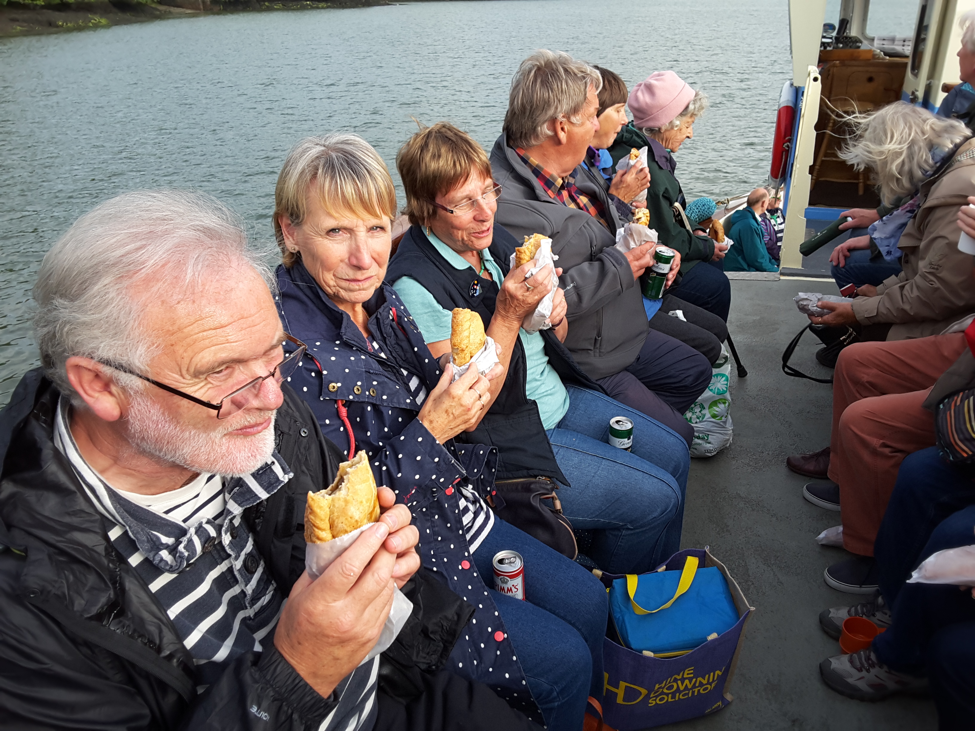 Friends enjoying the pasty supper on the River Fal.
